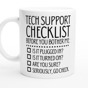 May include: White ceramic mug with black text that reads "Tech Support Checklist" and a list of questions: "Is it plugged in?", "Is it turned on?", "Are you sure?", "Seriously, go check."