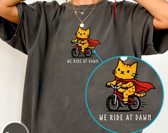 We ride at dawn cat biking Comfort Colors 1717 shirt, Ren Fair outfit, roleplaying tabletop gaming tee, matching cat family group tee