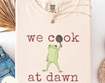 We cook at dawn Comfort Colors shirt, frog with frying pan cooking mom gift, goblincore chef dad tee, kitchen lover present, weird toad top