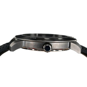 May include: A silver-toned wristwatch with a black rubber band. The watch has a round face with a silver bezel and a black dial.