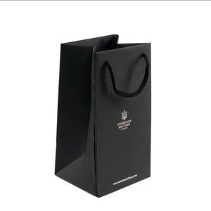 May include: A black paper shopping bag with black handles. The bag has a silver logo that says "UKRAINIAN MILITARY" and a website address.
