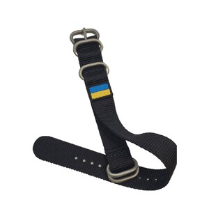 May include: Black watch strap with silver hardware and a small Ukrainian flag.
