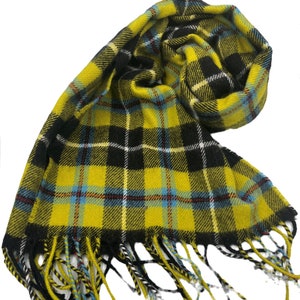 May include: Yellow and black plaid scarf with fringed edges. The scarf is made of a soft, woven fabric.