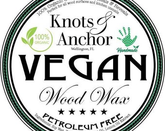 May include: A circular label with a black border and a green and white inner border. The label reads "Knots & Anchor" and "VEGAN Wood Wax." It also states "100% Organic & Vegan" and "PETROLEUM FREE."
