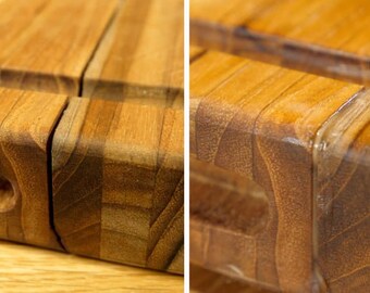 May include: Close-up of a wooden cutting board with a natural finish. The board is made of multiple pieces of wood that are joined together. The wood grain is visible and the board has a slight sheen.