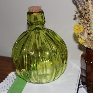 Green glass patterned bottle with cork.