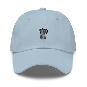 May include: A light blue baseball cap with an embroidered image of a coffee pot.