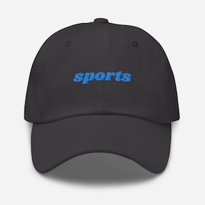 May include: A black dad hat with a blue embroidered word "sports" on the front.