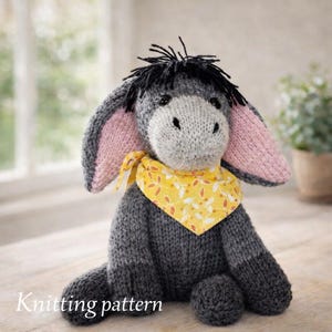 May include: A knitted donkey plush toy in shades of gray, with pink inner ears and a yellow patterned scarf. The donkey has black hair and is sitting on a wooden surface. The text "Knitting pattern" is at the bottom.
