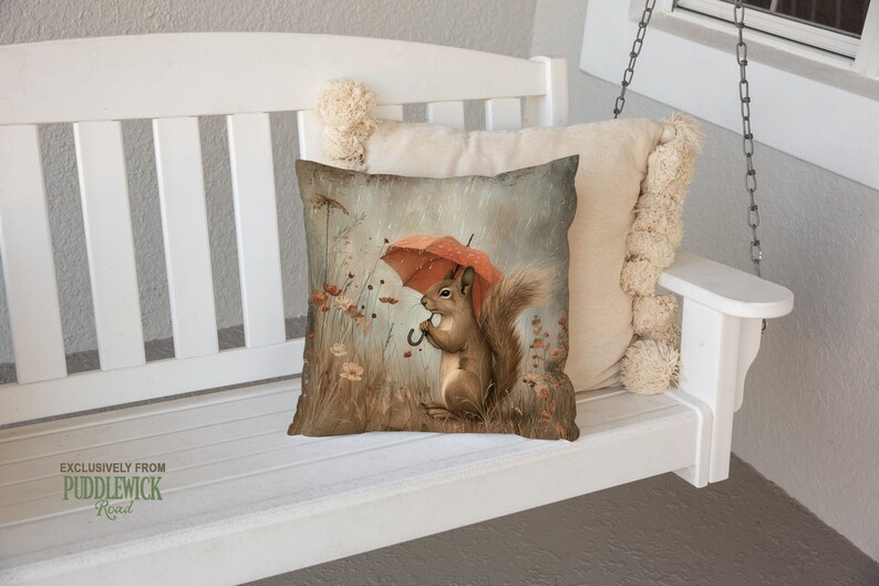 a pillow with a picture of a squirrel holding an umbrella