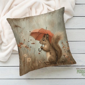 a pillow with a squirrel holding an umbrella