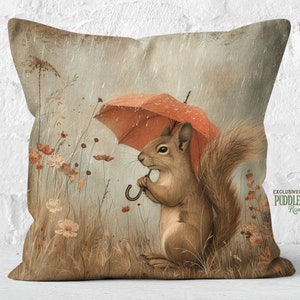 a pillow with a picture of a squirrel holding an umbrella