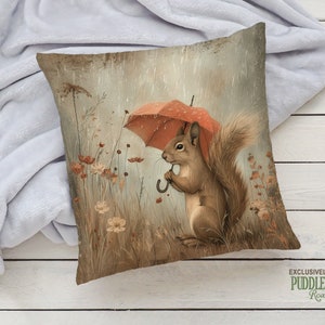 a pillow with a squirrel holding an umbrella