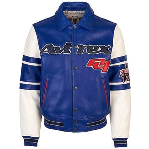 May include: A blue leather jacket with white sleeves. The jacket features the brand name "Avirex" in navy blue and red accents. The sleeves have white stripes and the jacket has a button-up front. A star patch is on the right sleeve.