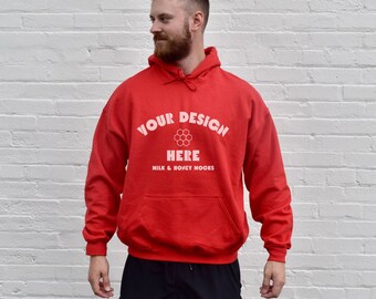 May include: Red hooded sweatshirt with the text "YOUR DESIGN HERE MILK & HONEY NOOKS" in white.