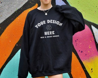 May include: Black sweatshirt with the text "YOUR DESIGN HERE MILK & HONEY MOCKS" printed on the front.