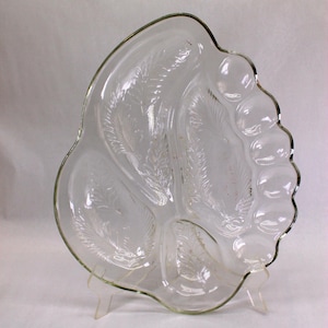 May include: A clear glass serving dish with three divided sections. The dish has a scalloped edge and a wheat design.