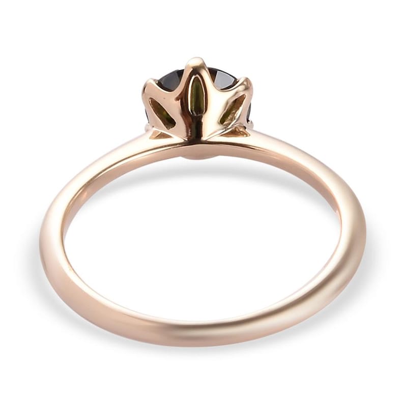 May include: A rose gold ring with a black gemstone set in a crown-shaped setting.