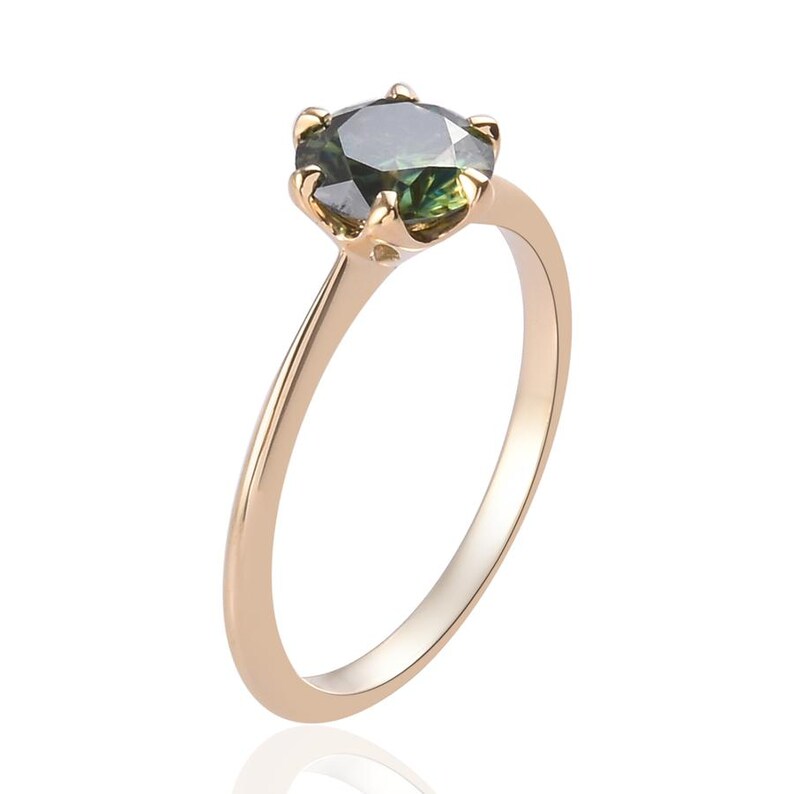 May include: A gold ring with a round, dark green gemstone set in a prong setting.