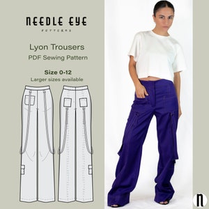 May include: A PDF sewing pattern for Lyon Trousers, a wide-leg style with multiple pockets and straps. The pattern is available in sizes 0-12, with larger sizes available. The image shows a model wearing a purple pair of the trousers.