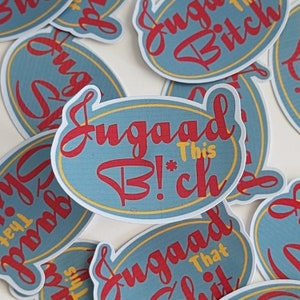 May include: A collection of oval-shaped stickers with a light blue background and red text. The stickers feature the phrase "Sugar Bitch" in a stylized font, with the words "This" and "That Shit" in yellow. A yellow border surrounds the text.