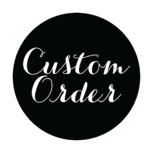 May include: A circular black graphic featuring the white text Custom Order written in a flowing, cursive script font. The design is centered within the circle, providing a clear and legible display of the words against the solid dark background.