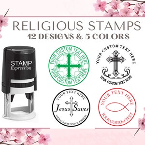 May include: A set of 12 religious stamp designs in 5 colors. The stamps feature various religious symbols, including crosses, a fish, and the words "Jesus Saves". The stamps are designed for use with a self-inking stamp pad.