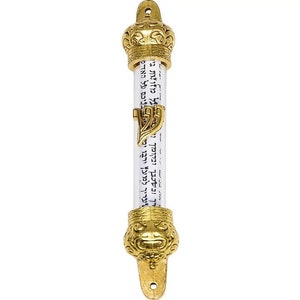 May include: A gold-colored mezuzah case with a crown design at the top and a lion's head at the bottom. The case holds a scroll with Hebrew text. The mezuzah has a loop at the top for hanging.