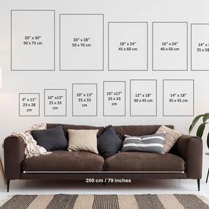 Different frame sizes are displayed on the white wall, with a long sofa as a scale comparison. This is a guide for frame sizes in portrait format