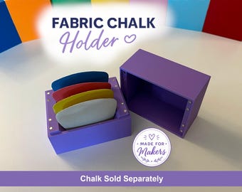 May include: A purple fabric chalk holder with a matching lid. The open holder contains five chalk pieces in white, yellow, red, and blue. The text "FABRIC CHALK Holder" is at the top, and "Chalk Sold Separately" is at the bottom.