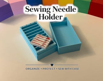 May include: A light blue sewing needle holder with the text "Sewing Needle Holder". The open container has multiple slots for needles, and a package of needles rests inside. The text "ORGANIZE • PROTECT • SEW WITH EASE" is at the bottom.