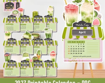 May include: A 2027 printable calendar with a Matcha Cafe theme. The calendar features monthly layouts with illustrations of matcha drinks and desserts. The text "2027 Printable Calendar - PNG" is at the bottom. The April calendar is displayed on a small easel.