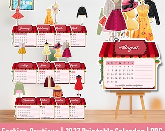 May include: A 2027 printable calendar featuring a fashion boutique theme. Each month is displayed under a red and white striped awning with illustrations of clothing on mannequins, including dresses, jackets, and hats. The calendar includes dates.