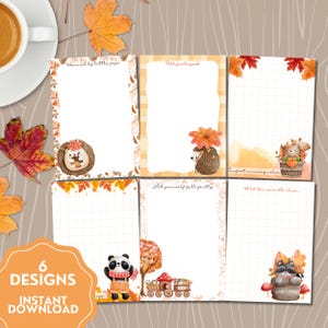 May include: Six printable notepaper designs with an autumnal theme. The designs feature illustrations of a hedgehog, panda, and raccoon, alongside phrases such as "Warmed by little joys" and "Comfort in every colour." The words "6 Designs" and "Instant Download" are also visible.