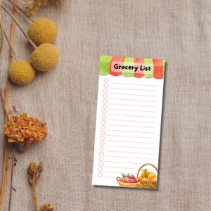May include: A printable grocery list with a red and green striped awning and a basket of fruit at the bottom. The list has 20 blank lines with circles for checking off items.