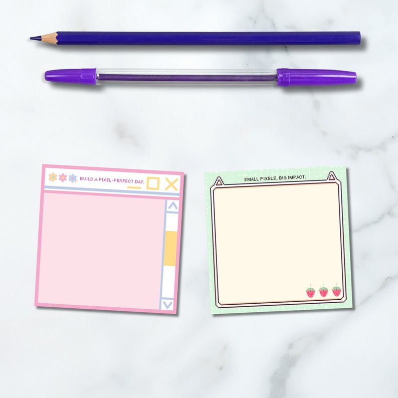 Puede incluir: Dos notas adhesivas cuadradas, una rosa y otra verde, con fondo blanco. La nota rosa tiene un borde azul claro y amarillo y el texto "BUILD A PIXEL-PERFECT DAY." La nota verde tiene un borde verde claro y el texto "SMALL PIXELS, BIG IMPACT." Hay tres fresas rojas en la nota verde.