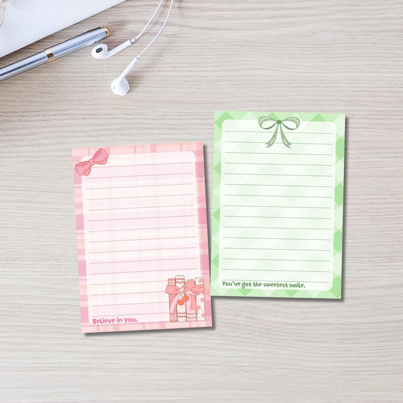 May include: Two lined notepads with bow and gift illustrations. One notepad is pink with the text "Believe in you." The other is green with the text "You've got the sweetest smile."