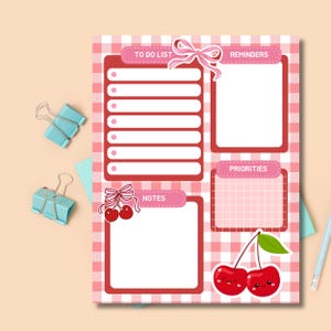 May include: A pink and white gingham patterned planner page with sections for to-do lists, reminders, notes, and priorities. Adorned with cherry and bow illustrations, and light blue binder clips.