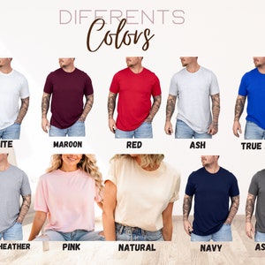 May include: A display of t-shirts in various colors, including white, maroon, red, ash, true royal, athletic heather, pink, natural, navy, and asphalt. The word "Colors" is written in a cursive font above the shirts.
