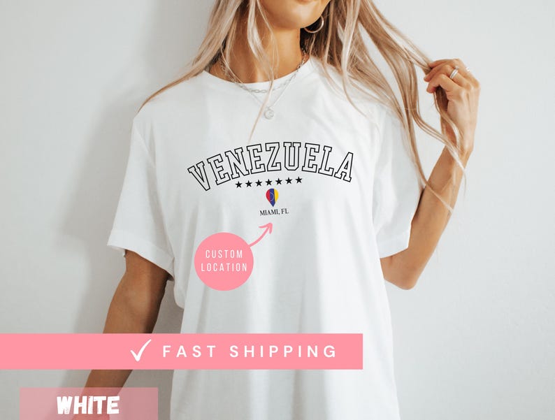 May include: White t-shirt with the word "VENEZUELA" in black, arched text above five stars. Below, a graphic of a flag and the text "MIAMI, FL". A pink circle with "CUSTOM LOCATION" is below the graphic.