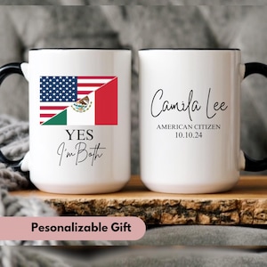 May include: Two white mugs with black handles. The mug on the left has a design of the American and Mexican flags with the text "YES I'm Both". The mug on the right has the text "Camila Lee AMERICAN CITIZEN 10.10.24".