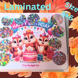 May include: A sheet of 5x6 holographic stickers featuring a birthday card with three chipmunks, a cake, and the text "Happy Birthday". The stickers are laminated and have a shiny, iridescent finish.