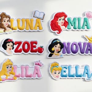 May include: Embroidered patches featuring Disney princess characters and names: Luna, Mia, Zoe, Nova, Lila, and Ella. Each patch has a princess image and a name in a colorful, stylized font. Additional elements include a book, apple, seashell, crown, and lamp.