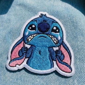 May include: A set of three ceramic mugs with a speckled, matte finish in cream, light grey, and dark grey. Each mug has a simple, minimalist design and a rounded handle.