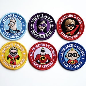 May include: Six colorful embroidered patches featuring characters from a superhero movie. Each round patch has a different character and text, including "Frozone's Ice," "Violet's Force," and "Elastigirl's Flex." The patches are in various colors like blue, purple, red, and yellow.
