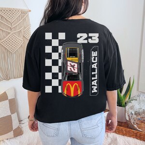 May include: Black t-shirt with a checkered flag design, a race car with the number 23, and the text "WALLACE" and "McDonald's".
