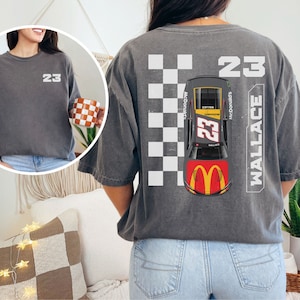 May include: A gray t-shirt with a checkered pattern, a race car, and the text "23 WALLACE" and "McDonald's".