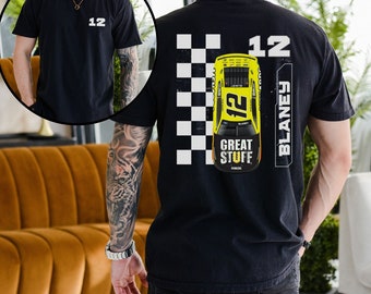 Op de afbeelding: Zwart T-shirt met een wit nummer 12 op de voorkant en een geruit vlagontwerp met een gele raceauto op de achterkant. De auto heeft het nummer 12 en de naam Blaney erop. De auto heeft ook de woorden "Great Stuff" erop.