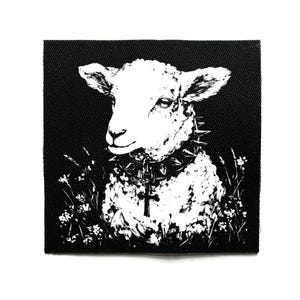 May include: Black and white patch featuring a sheep wearing a studded collar and a cross pendant. The sheep is surrounded by stylized flowers, creating a contrast between innocence and a darker aesthetic. The patch is square.