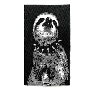 May include: Black and white patch depicting a sloth with a spiked collar. The sloth is looking upwards. The background has a textured appearance.